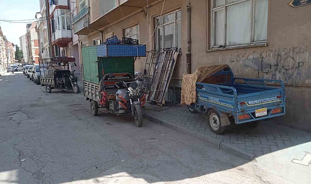 Geri dönüşüm işçilerinin motosikletleri kaldırımdaki engelli rampasını kapatıyor