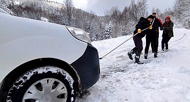 Aracı kurtarmak için her yolu deneyen köylülerin yardımına karla mücadele ekipleri yetişti