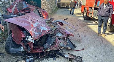 Kamyondan düşen iş makinesi park halindeki otomobili ezdi