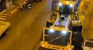 Dev iş makinası Erdek'te caddeye sığmayınca kamu malını parçalayarak yol aldı