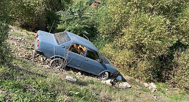Dereye uçan otomobilden burnu bile kanamadan çıktı